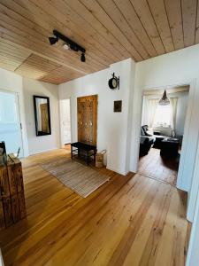 欣费尔德Ferienwohnung Peters的客厅铺有木地板,设有木制天花板。