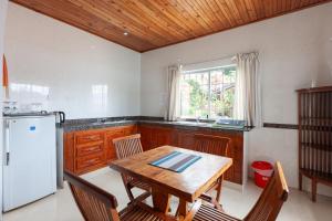 贝圣安那科特梅尔小屋的厨房配有木桌和白色冰箱。