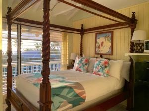 科纳大岛静养旅馆的一间卧室设有天蓬床和窗户。