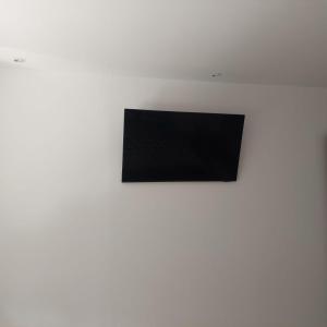 锡比乌Apartament Casa Dia的白色墙壁上配有平面电视