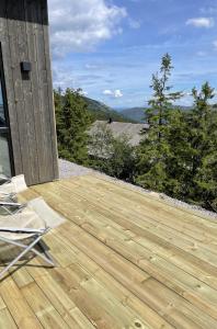 伯Stylish cabin at Lifjell with jacuzzi and sauna的山景木制甲板