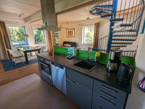 Stelle"Buena Vista" Ashausen/Hamburg的厨房配有带水槽和楼梯的柜台。