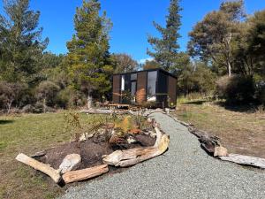 RangihaeataRuru Tiny House的一座用木头建造的房屋,带有花园