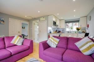 Saint TudyCornish Holiday - 91 Hengar Manor的一间带两张紫色沙发的客厅和一间厨房