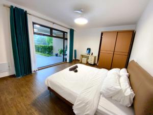 振林山Forest City Golf Course Resort Villa by Lions Bay的卧室设有白色的床和大窗户