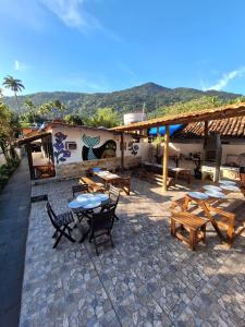 阿布拉奥Ilha Grande Inn的一座配有桌椅的庭院和一座建筑