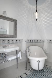 波兰尼卡-兹德鲁伊帕拉卡密恩尼科旅馆的白色的浴室设有浴缸和水槽。