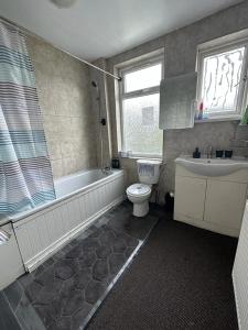 伦敦Affordable Private Rooms in Wembley的带浴缸、卫生间和盥洗盆的浴室