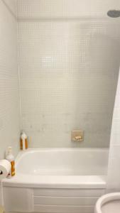 多伦多The Parkdale Hostellerie的白色的浴室设有浴缸和卫生间。