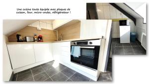 圣布里厄Sous les toits – tout confort的厨房配有白色橱柜和烤箱。