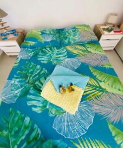 圣吕斯L’Appart Watalibi的一间卧室配有一张蓝色和绿色的床铺