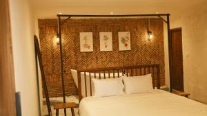 绥和市Vũ House Phú Yên- Boutique Room & Breakfast的一间卧室配有一张带木制床头板的床
