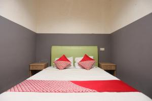 名古屋OYO 92988 City Room的一间卧室配有一张带两个红色枕头的床
