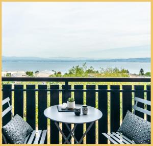 埃维昂莱班Appartement T2 Vue Lac Léman Evian les Bains的海景阳台上的桌椅