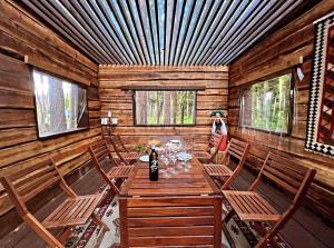 富士河口湖Glamping Villa Hanz Kawaguchiko的一间带木桌和椅子的用餐室