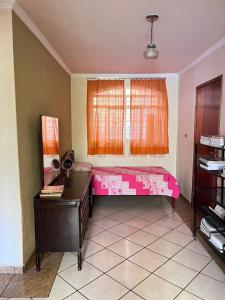 戈亚尼亚Pousada Lopes na Fama的一间设有粉红色床铺和窗户的客房