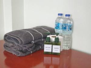 涛岛Tommy Resort Koh Tao的桌子上放着一大堆毛巾和瓶装水