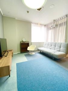 福山ROSE ROOM的带沙发和蓝色地毯的客厅
