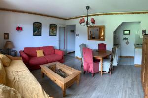 谷雪维尔Résidence Saboia A29 Clés Blanches Courchevel的客厅配有红色的沙发和桌子