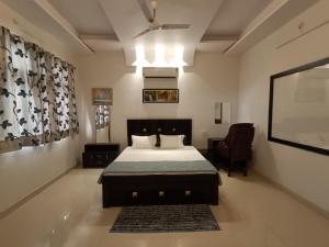 贾巴尔普尔Leela Homestay Jabalpur - Lily - 2 BHK Luxury appartment的一间卧室配有一张床和吊扇