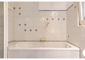 维也纳Deluxe 3BR Apt. Wiener Stadthalle - Suitable for Longstays的白色瓷砖浴室内的白色浴缸