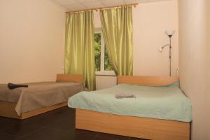 雷泽克内VILLA ROZA Guest House的一间卧室设有两张床和窗户。