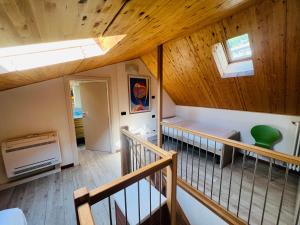 德尔维奥Bellavista Giulia on Lake Como的一间设有木制天花板和楼梯的客房