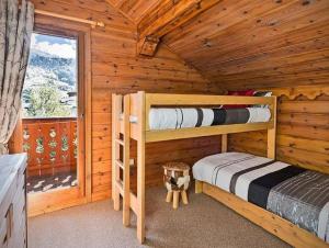 莱斯奥琉斯Meribel Les Allues Ski Chalet with beautiful views的小木屋内一间卧室配有两张双层床