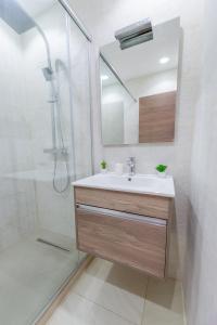 KoubaAppartement Luxueux à Kouba的浴室配有盥洗盆和带镜子的淋浴