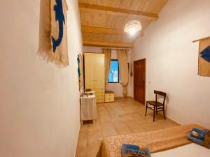 卡洛福泰Guest House Calalunga Scogliera的配有床、桌子和椅子的房间