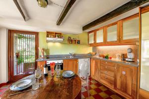 ArannoCasa Dell'Antonio - Happy Rentals的厨房配有木桌和水槽。