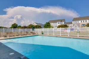大洋城Luxury Ocean City Retreat with Beautiful Bay Views的一个带椅子和白色围栏的游泳池