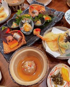 由布市湯布院 旅館 やまなみ Ryokan YAMANAMI的一张桌子上有很多种不同的食物