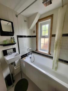 拉伊Aviemore Rye的一间带大浴缸和水槽的浴室