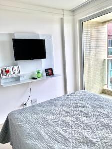 卡贝德卢Lindo Flat completo em Intermares 404的一间卧室配有一张床和一台平面电视