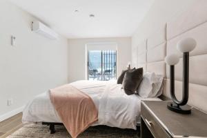 纽约Unbeatable 3BR with Private Patio in Upper East Side的白色的卧室设有一张大床和一个窗户