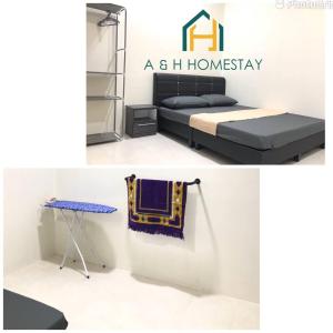 安顺A&H Homestay Teluk Intan的家庭卧室配有一张床和一张桌子