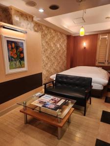 Koshigayaスタイリッシュ武里的酒店客房配有一张床和一张茶几
