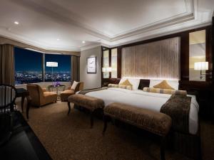 大阪Hotel Hankyu International的酒店客房设有一张大床和一张桌子。