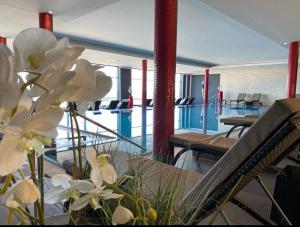 沙博伊茨海湾酒店的一间设有游泳池的房间,并拥有一些白色的鲜花