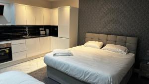 曼彻斯特OYO Cheetham Hill Guest House的一间卧室配有一张带白色橱柜的大床