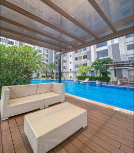 宿务Horizons 101 Condo in Cebu City的带沙发的庭院和大楼内的游泳池
