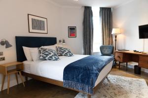 伦敦THE KNIGHT OF NOTTINGHILL的配有一张床和一张书桌的酒店客房