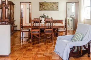 彼得罗波利斯Chamosa e aconchegante casa em Petrópolis VGL041的一间带木桌和椅子的用餐室