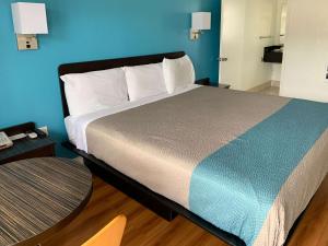 皮斯莫比奇皮斯莫海滩6号汽车旅馆 - 太平洋的一间卧室设有一张蓝色墙壁的大床