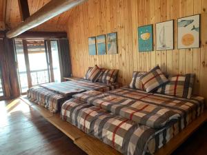 和平Hồ Tằm Homestay的木墙客房的两张床