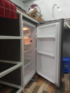 蒙巴萨Paradise Apartment的厨房里空着冰箱,门开