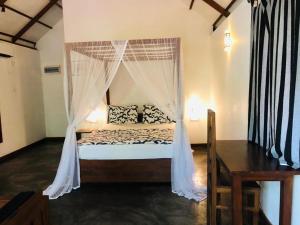 达瓦拉维The Countryside Udawalawe的一间卧室配有一张带蚊帐的床