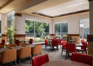 安娜堡安娜堡希尔顿花园酒店的餐厅设有桌椅和窗户。