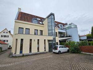 菲尔德施塔特Maisonette-Wohnung Airport/Messe Stuttgart - Balkon - Parkplatz - Netflix的停在大楼前的白色汽车